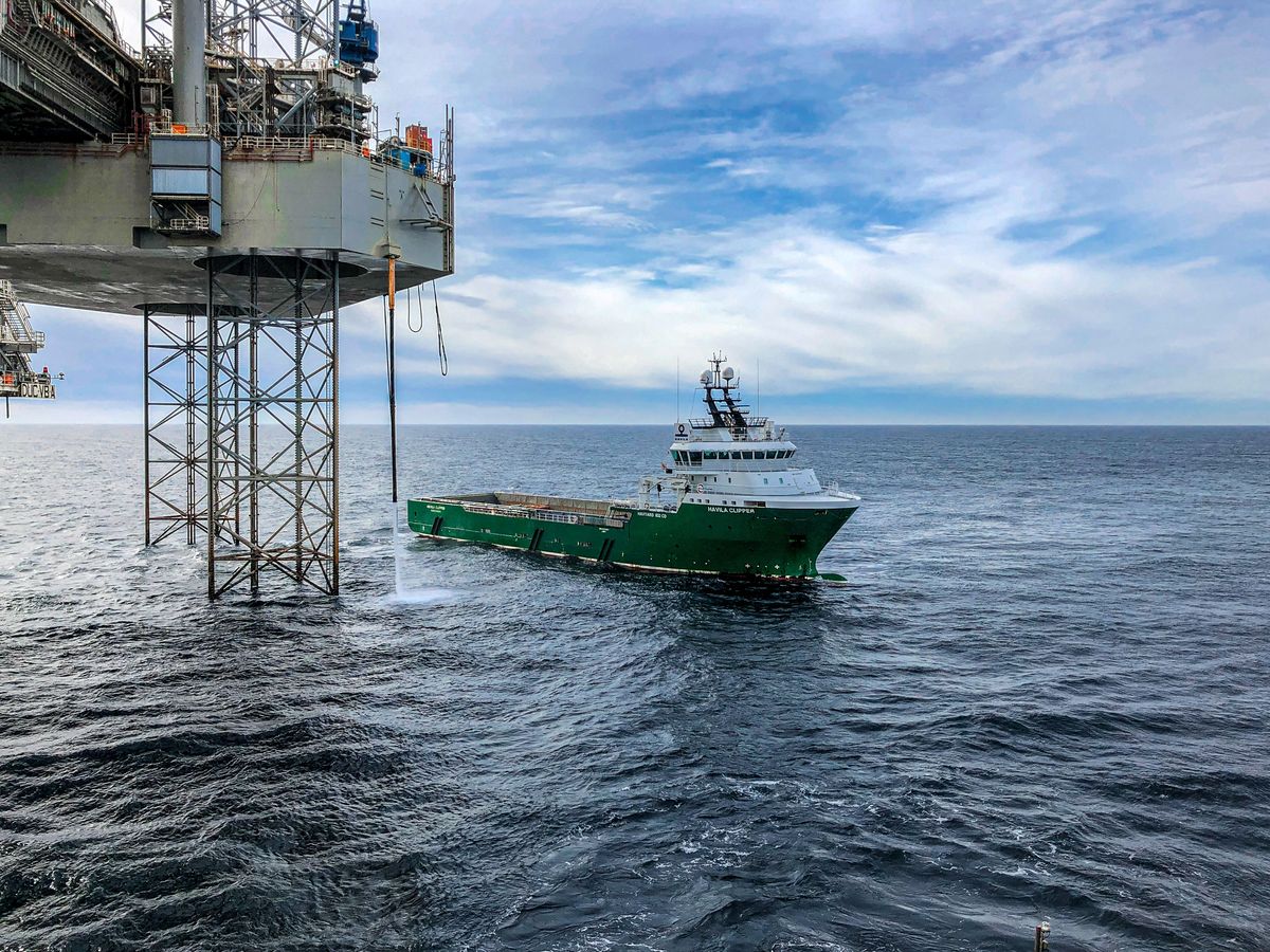Supply vessel approaching an offshore oil platform